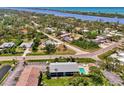 Aerial view of condos featuring a refreshing pool and well-maintained grounds near a scenic waterway at 1730 Manasota Beach Rd # 215, Englewood, FL 34223