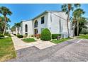Charming condo building with well-manicured landscaping, offering a welcoming curb appeal in a sunny setting at 1730 Manasota Beach Rd # 215, Englewood, FL 34223