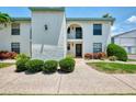 Inviting condo exterior with tidy landscaping, providing a warm and welcoming entrance at 1730 Manasota Beach Rd # 215, Englewood, FL 34223