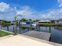 Private boat dock with a boat lift and a picturesque waterfront setting at 18302 Burkholder Cir, Port Charlotte, FL 33948