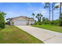 A lovely home showcasing a large driveway leading to a spacious garage and lush landscaping at 2267 Yalta Ter, North Port, FL 34286