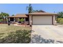 Inviting single-story home featuring a spacious 2-car garage and well-kept landscaping at 2331 Mission Valley Blvd, Nokomis, FL 34275