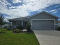 Charming single-story home featuring a well-manicured lawn and attached two-car garage at 3003 58Th E Way, Palmetto, FL 34221