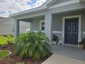 Inviting front porch adorned with lush landscaping and stylish decor at 3003 58Th E Way, Palmetto, FL 34221