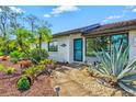A charming home with a tile roof, well-maintained landscaping, and a welcoming walkway at 301 Gulf Dr, Venice, FL 34285