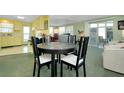 A comfortable dining area that flows into the kitchen and living spaces, with a round table and stylish chairs at 304 Roma Rd, Venice, FL 34285