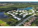 Beautiful aerial view of single-story homes surrounded by lush greenery and serene lakes at 3141 Heron Shores Dr, Venice, FL 34293