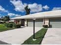 Charming villa with a two-car garage, lush landscaping, and an inviting entrance at 3141 Heron Shores Dr, Venice, FL 34293
