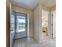 Inviting foyer with tile flooring leading to a bedroom in this charming home at 3141 Heron Shores Dr, Venice, FL 34293