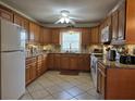 Bright kitchen with light wood cabinetry, granite countertops and updated appliances at 3311 Papaya Rd, Venice, FL 34293