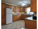 Well-lit kitchen featuring abundant cabinets, granite countertops, tile backsplash, and modern appliances at 3311 Papaya Rd, Venice, FL 34293