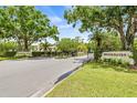 Brookhaven and Farrell Park entrances with well maintained landscaping and tree lined street at 3382 Mermoor Dr # 3201, Palm Harbor, FL 34685