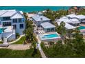 Aerial shot of luxurious home with pool, hot tub, and waterfront access at 3516 Casey Key Rd, Nokomis, FL 34275
