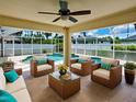 Inviting screened-in patio with stylish furniture overlooking the sparkling swimming pool for relaxation and entertainment at 4103 Kinlock St, North Port, FL 34286