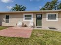 The home's front exterior features a small patio with chairs, complemented by a lush green lawn at 4192 Tarpon Rd, Venice, FL 34293