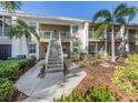 Condo exterior with landscaped pathway and stairs leading to upper-level units at 421 Cerromar Ter # 471, Venice, FL 34293