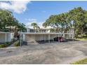 Community parking area with carports and well-maintained landscaping around the complex at 421 Cerromar Ter # 471, Venice, FL 34293