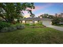 Beautiful home exterior with manicured landscaping, a two car garage, and a well-kept lawn at 427 Autumn Chase Dr, Venice, FL 34292
