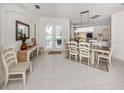 Bright dining room flows into living spaces with a view to the lanai and pool at 463 Park Trace Blvd, Osprey, FL 34229
