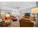 Comfortable living room with modern furnishings, tile floors, ceiling fan, and ample natural light at 4912 Bella Terra Dr, Venice, FL 34293