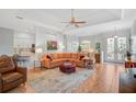 Spacious living room featuring a large sectional sofa, tile flooring, and views into kitchen and dining area at 4912 Bella Terra Dr, Venice, FL 34293
