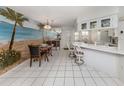 Bright dining room with tile flooring, wall art, and bar stool seating at 528 W Venice Ave # 1, Venice, FL 34285