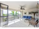 Relaxing screened lanai with comfortable seating and ceiling fan overlooking the lush community at 5674 Palmer Circle Dr # 203, Bradenton, FL 34211