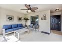 Comfortable screened porch featuring stylish furniture, fan, and a welcoming 