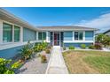 Close up of the front of the home showing the walkway and manicured landscape and plants at 5872 Monroe Rd, Venice, FL 34293