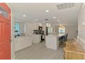Open concept kitchen featuring white cabinets, stainless appliances, and a large island at 5872 Monroe Rd, Venice, FL 34293
