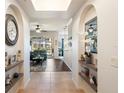 Bright foyer with decorative shelving, tiled floors, and an arched entryway that leads to the living space at 600 Gardens Edge Dr # 613, Venice, FL 34285