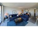 Comfortable living room featuring sofas, glass table, and sunny patio access at 612 Bird Bay S Dr # 308, Venice, FL 34285