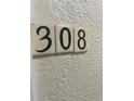 Close-up of the unit number 308 displayed on the exterior wall at 612 Bird Bay S Dr # 308, Venice, FL 34285