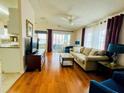 Open living room with hardwood floors and sliding doors at 615 S Green Cir, Venice, FL 34285