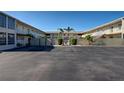 The property's paved courtyard, enclosed by buildings, offers ample parking and serene aesthetics at 701 Barcelona Ave # 101, Venice, FL 34285