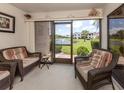 Relaxing Florida room with comfortable seating and a serene view of the pond at 800 Capri Isles Blvd # 124, Venice, FL 34292