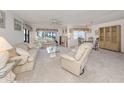 Spacious living area with neutral decor, large windows, and open access to the dining area at 800 Capri Isles Blvd # 124, Venice, FL 34292