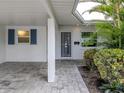 Inviting front entrance with tiled walkway and a security screen door at 832 Whitecap Cir # 5, Venice, FL 34285