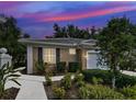 Charming home with a landscaped front yard, walkway and tiled roof at 912 Barclay Ct, Venice, FL 34293