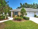 Inviting home exterior featuring a well-manicured lawn and appealing landscaping at 912 Barclay Ct, Venice, FL 34293
