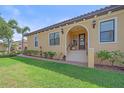 Inviting home exterior features a manicured lawn and covered entrance framed with elegant archways and lush greenery at 9220 43Rd W Ter, Bradenton, FL 34209
