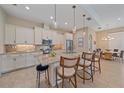 Gourmet kitchen features granite countertops, stainless appliances, tile backsplash, and an island with seating at 9220 43Rd W Ter, Bradenton, FL 34209