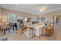Bright living room with neutral tones, tile floors, a decorative fan, and an open floor plan at 9220 43Rd W Ter, Bradenton, FL 34209