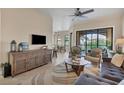 A bright, cozy living room featuring neutral tones, tile floors, elegant furniture, and a sliding glass door to the patio at 97 Vivante Blvd # 306, Punta Gorda, FL 33950