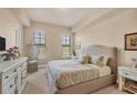 A serene main bedroom with plush carpeting, natural light, and a neutral color palette at 97 Vivante Blvd # 306, Punta Gorda, FL 33950