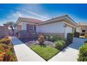 Charming single-story home with manicured landscaping and a well-maintained walkway leading to the entrance at 102 Mestre Pl, North Venice, FL 34275