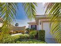 Beautiful home with lush landscaping, charming exterior details, and a well-maintained front yard at 102 Mestre Pl, North Venice, FL 34275
