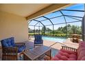 Relaxing screened-in patio featuring comfortable seating and views of the pool at 10209 Fiddlewood Dr, Venice, FL 34293