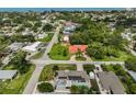 An aerial view showcases a neighborhood with lush landscaping and a glimpse of the nearby ocean at 1099 Nokomis S Ave, Venice, FL 34285