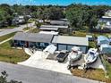 An aerial view of a home with a long driveway, a garage, and two boats parked in the drive at 1103 Lucille Ave, Nokomis, FL 34275